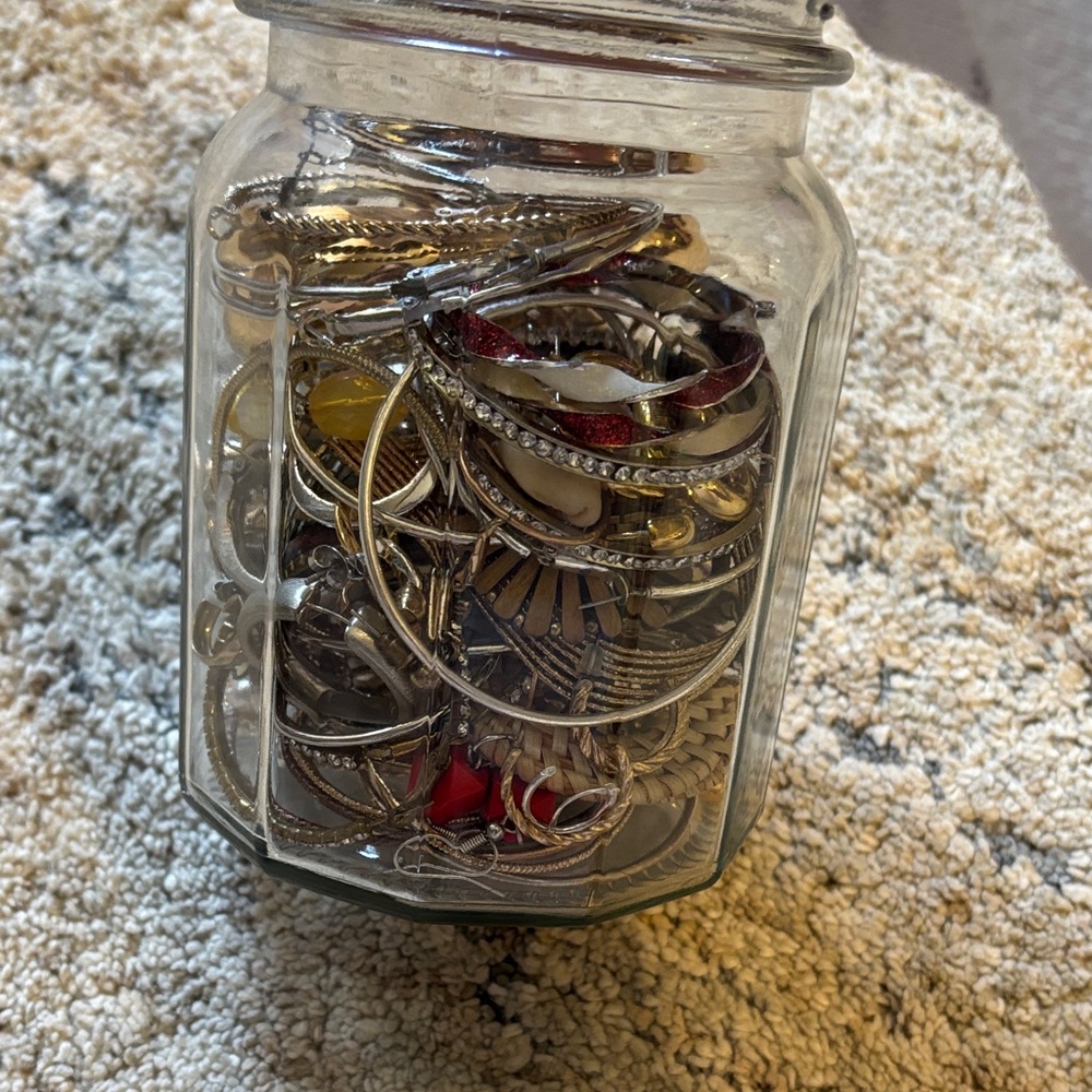 Mystery jar of gold and silver tone hoop earrings